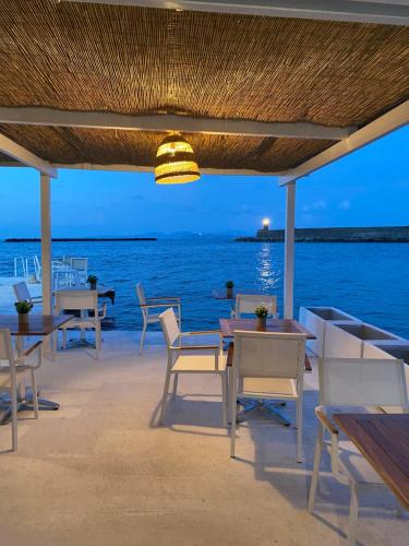 a restaurant on the beach with tables and chairs at Pagoda Lifestyle Hotel in Ischia