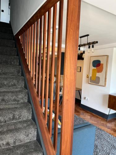 a staircase in a house with wooden railings at Duplex Apartment Harbourside city centre in Bristol