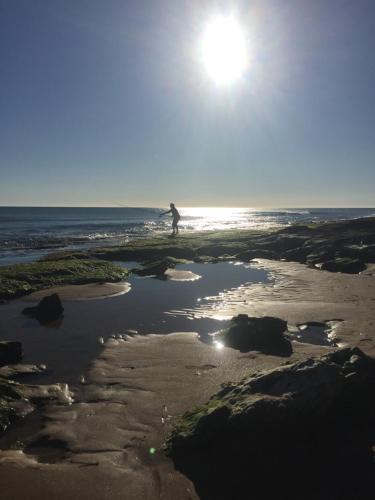 a person walking in the water on a beach at Jess & Joe's in Castelvetrano Selinunte