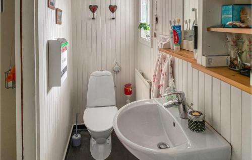 a small bathroom with a toilet and a sink at Beautiful Home In Sala With 2 Bedrooms And Wifi in Sala