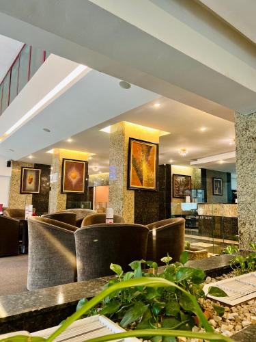 a hotel lobby with chairs and a reception desk at Hotel Piatra Mare in Poiana Brasov