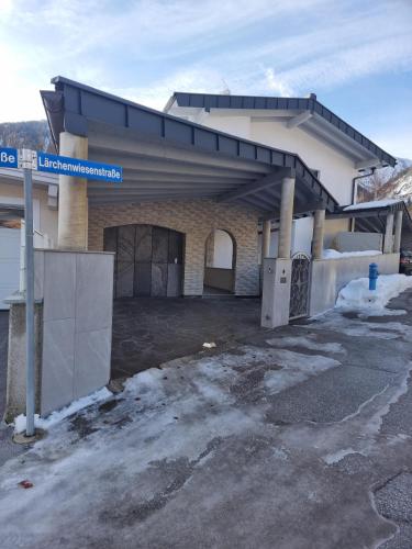 a building with a parking lot in front of it at Mountain Pearl in Maurach