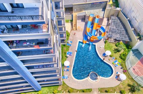 an overhead view of a pool with a water slide at Albimo Loft by Newinn in Mahmutlar