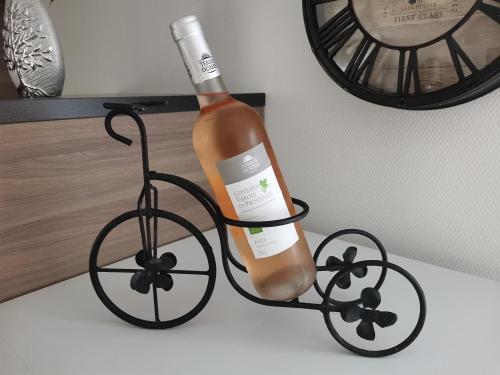 a bottle of wine in a bike holder on a counter at Gîte - Chambres d'Hôtes La Belle Hélène in Bressuire