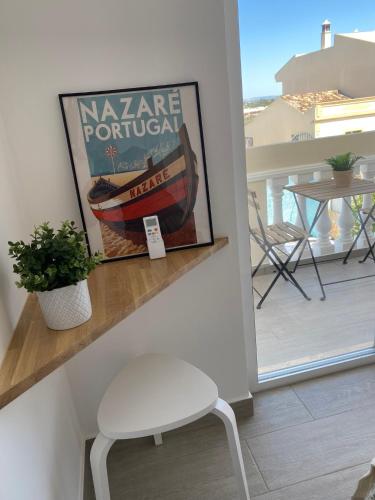 a white stool sitting on a shelf next to a balcony at Vila Luisa Anabela Piscine et Jacuzzi only family in Albufeira