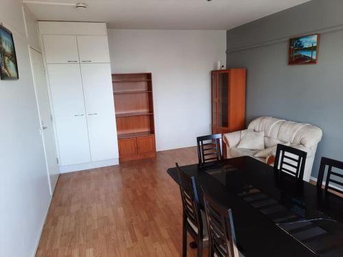 a living room with a table and chairs and a couch at 50m2 Cozy Apartment, FREE Parking 20 min to Center in Espoo