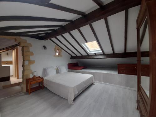 a bedroom with a white bed in a attic at AGUR MAITEA in Biarritz