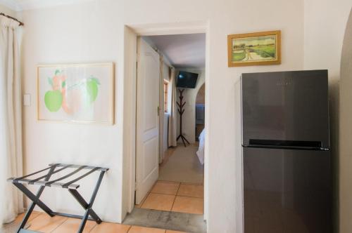 a hallway with a refrigerator in a room at Golfer's Lodge in Edenvale
