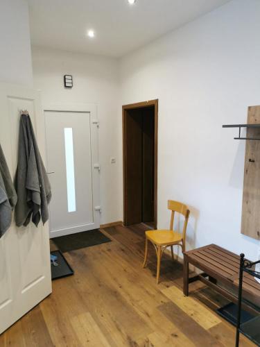 a room with a table and a chair and a door at Wohnung mit Parkplatz und Garten in Donawitz