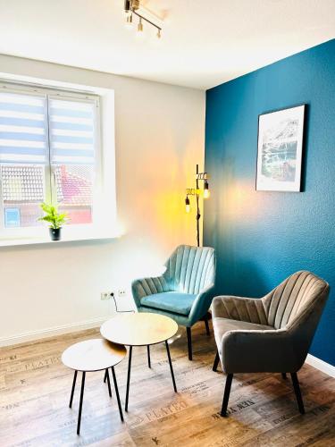 a living room with two chairs and a table at BlueLagoon in Schweinfurt