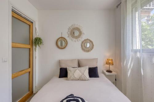 une chambre blanche avec un lit et une fenêtre dans l'établissement Sérénité et beauté à Vincennes,5mn de métro, à Vincennes