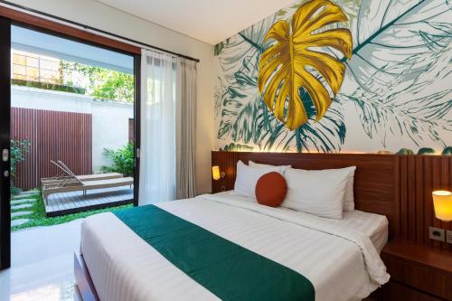 a bedroom with a large bed with a tropical wallpaper at Cove Ransha Stay in Sanur