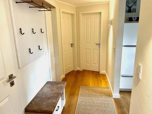 a hallway with a door and a bench in a room at Haus-Holiday-Walkenried-Harz-Fewo-2 in Walkenried