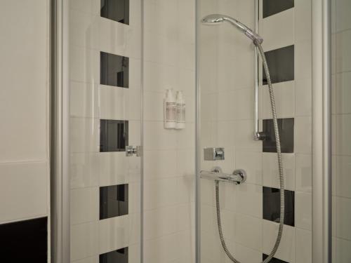 a shower with a glass door in a bathroom at IntercityHotel Bremen in Bremen
