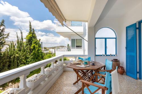 a balcony with a wooden table and chairs at Breeze 1BD Apartment by BluPine in Athens