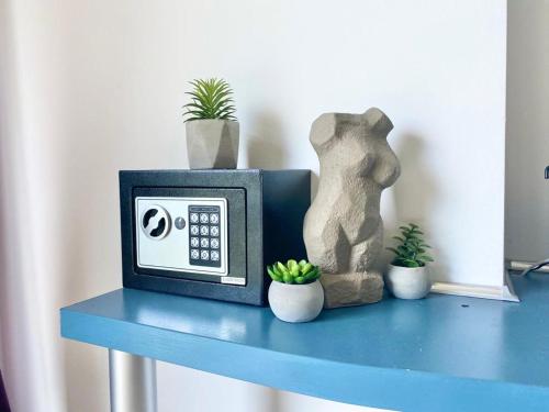 a clock sitting on a blue table with plants at Design Studio in Atlantis Resort&SPA, Burgas Airport in Burgas City