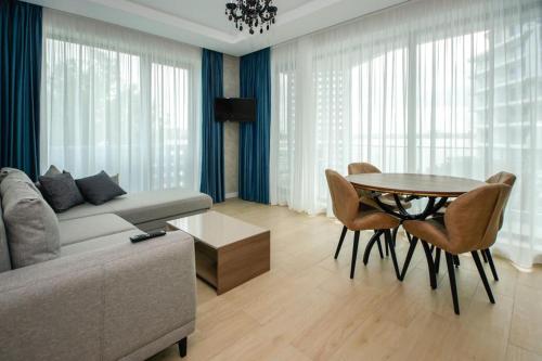 a living room with a couch and a table at Lake On Apartments in Mamaia