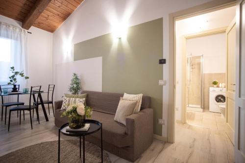 a living room with a couch and a table at Chic apartment in the historic center of Perugia in Perugia