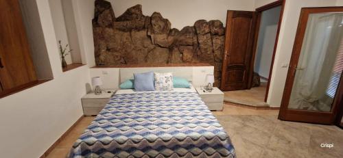 a bedroom with a large bed with blue pillows at B&B Su Terrabinu in Porto Rotondo