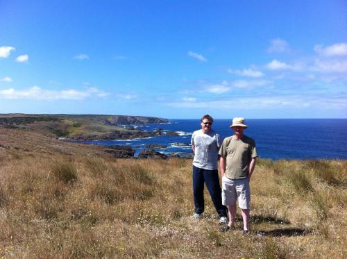two people standing on a hill overlooking the ocean at Island Breeze Motel in Currie