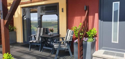 a patio with chairs and a table on a porch at Glewitz Am Alten Fährhaus in Garz-Rügen