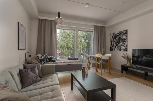 a living room with a couch and a table at DP Apartments Vaasa in Vaasa