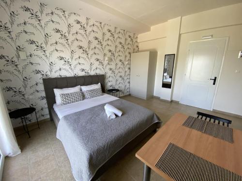 Un dormitorio con una cama y una mesa dentro. en Ai Nies Studios, en Soúrpi