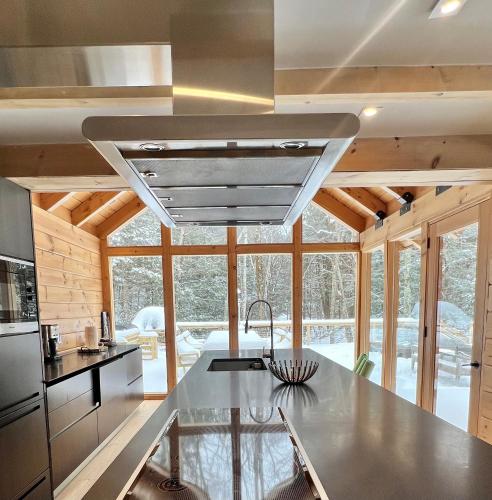 a kitchen with a stainless steel counter top and a large window at WoodHunterHome in Platte Clove