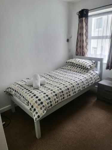 a bedroom with a bed with a polka dot bedspread at St Georges Guest House in St Peter Port