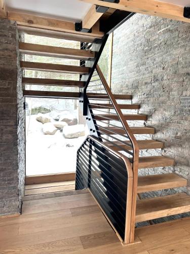 a wooden staircase in a brick building with a window at WoodHunterHome in Platte Clove