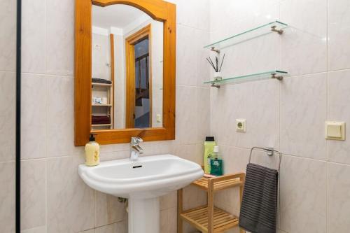 a bathroom with a sink and a mirror at Seamount, a beautiful house overlooking Tamariu in Tamariu