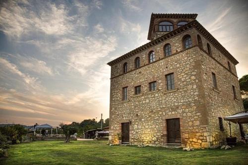 a large stone building with a tower on top at I Segreti del Borgo in Penna in Teverina