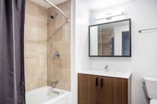 a bathroom with a sink and a mirror at Central Sq 2BR w Gym WD Doorman nr T BOS-316 in Cambridge