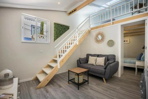a living room with a staircase and a couch at Casa da Villa in Vila do Bispo