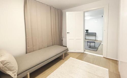 a bedroom with a bed and a door to a room at Unique 3 Bedroom Apartment in Vibrant Frederiksberg in Copenhagen
