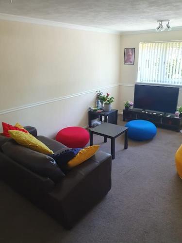 a living room with a couch and a tv at 1bedroom flat wt ext sofa chair in Horsham