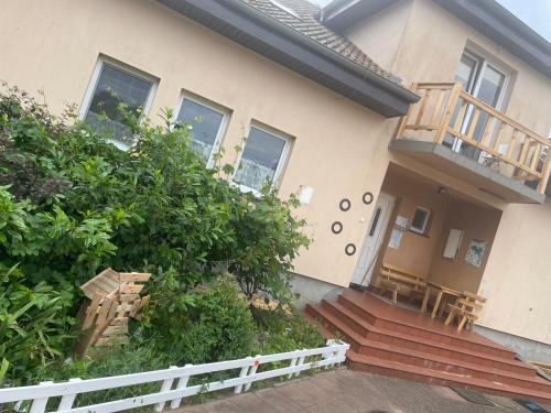 a house with a porch and stairs to the entrance at Kopice " Kowalczyk In Nature Parks Blue Velo" in Gollnow