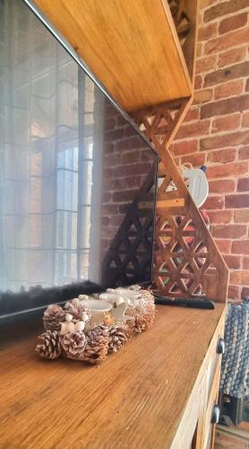 a wooden counter with a window and a brick wall at Old Town #Menorah #MostCity in Dnipro