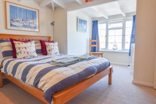 a bedroom with a large bed with blue curtains at Harbour Life in Yarmouth