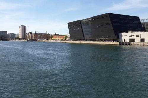 a large body of water next to a building at Unique 3 Bedroom Apartment in Vibrant Frederiksberg in Copenhagen