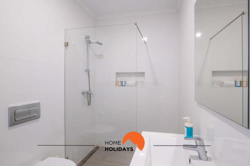 a white bathroom with a shower and a sink at #096 Oceanside, Fully Equiped, 50 mts Beach in Albufeira