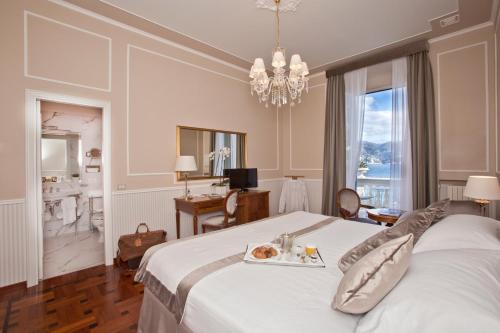 a bedroom with a bed with a tray of food on it at Grand Hotel Miramare in Santa Margherita Ligure