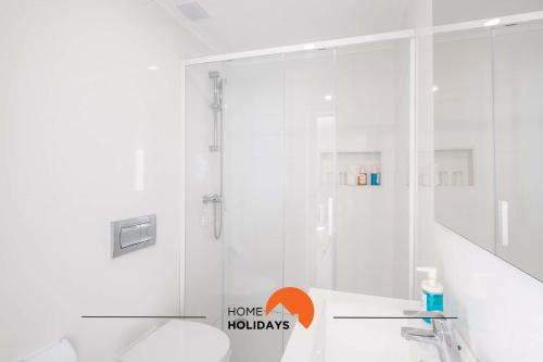 a white bathroom with a shower and a toilet at #097 Casa Antonieta 2 by Home Holidays in Albufeira