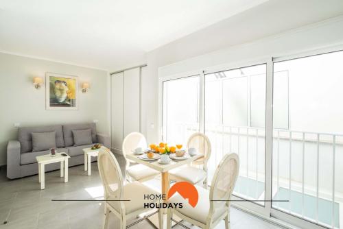 a living room with a table and chairs and a couch at #097 Casa Antonieta 2 by Home Holidays in Albufeira