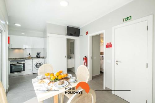 a kitchen with a table with a bowl of fruit on it at #097 Casa Antonieta 2 by Home Holidays in Albufeira
