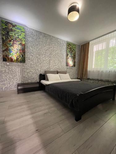 a bedroom with a large bed in a room at FAMILY apartment in Vinnytsya
