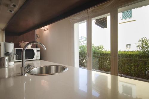 a kitchen counter with a sink and a window at LETS HOLIDAYS Luxury house in Cala Llevado in Tossa de Mar