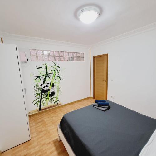 a bedroom with a bed and a wall with a soccer ball on it at Pintor 31 in Valencia