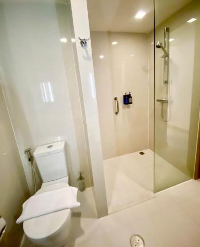 a bathroom with a toilet and a shower at Travelodge Pattaya in Pattaya Central