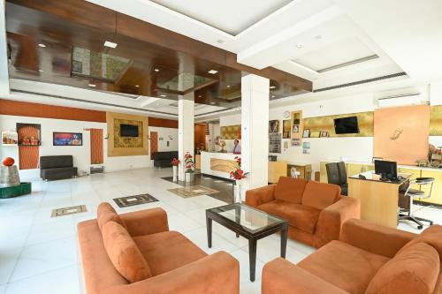 a large living room with couches and a table at Hotel Krishna - By RCG Hotels in New Delhi